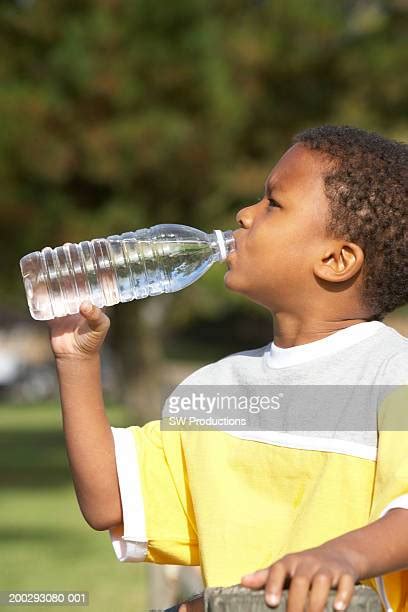 African American Boy Drinking Water Photos And Premium High Res
