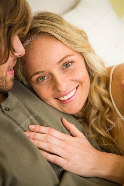 Couple Cuddling In The Bedroom Stock Photo By ©wavebreakmedia 102179412