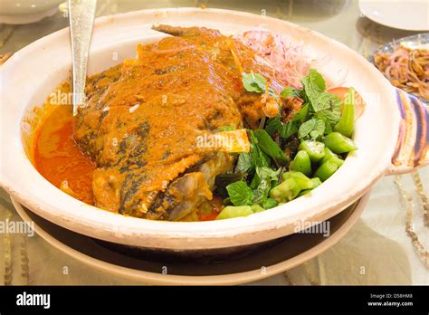 Nyonya Fish Head Curry With Mint Leaves Okra Tomato And Onions Stock