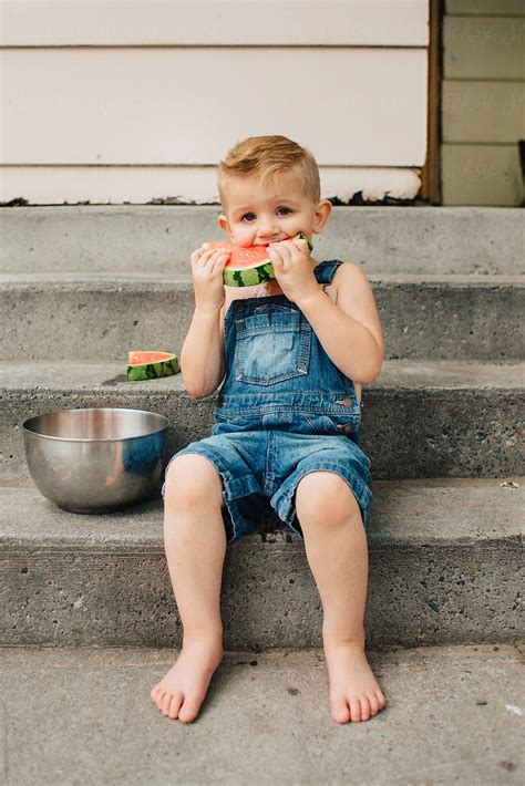 Babe Siblings Eating Fresh Watermelon Outside In Early Summer Del Colaborador De Stocksy