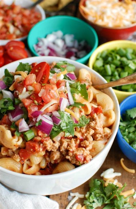 Push the onion and garlic to the sides of the instant pot, creating a well in the center. Instant Pot Turkey Taco Pasta Image 7 - A Cedar Spoon