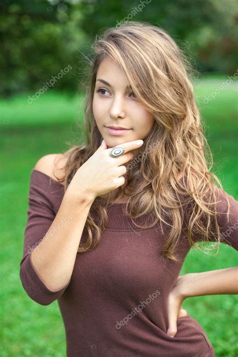 Beautiful Young Spring Brunette Posing Outdoors Stock Photo By ©envivo