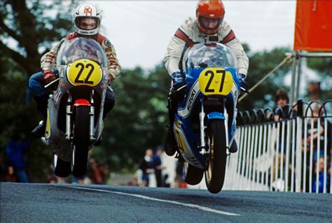 Competitors in the isle of man tt races held from 1907. Two riders in the air during the 1979 Isle of Man TT ...