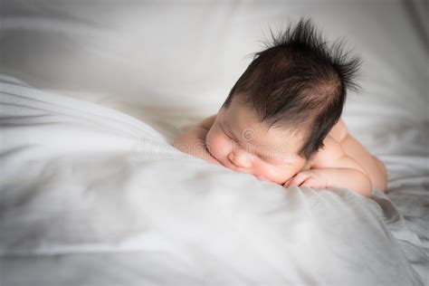 Infant Boy Smiles In His Sleep On White Bed Stock Photo Image Of