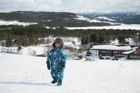 Boy Child Kid Walking Playing In Snowy Mountain In Winter Wonderland