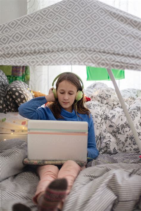 Tween Girl In Her Room Under A Cubby House Listening To Music By