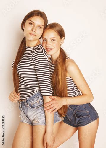 Two Cute Teenagers Having Fun Together Isolated On White Imagens E Fotos De Stock Royalty Free