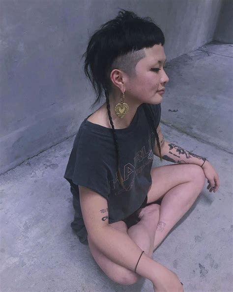 The modern mullet is a hairstyle that pairs a long tail with very short hair on the sides and back. woman with modern mullet / shaved sides with braids ...