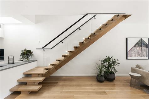 Timber Centre Carriage Stair With Black Steel Handrails And Glass Patch