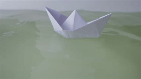 Blue Paper Boat On Surfaces Of Water Stock Footage Video 1193314