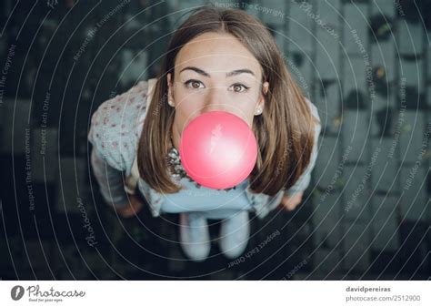 Top View Of Young Teenage Girl Blowing Bubble Gum A Royalty Free