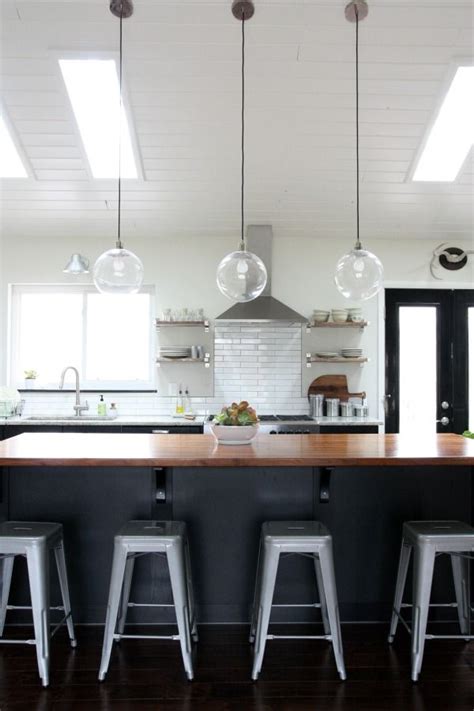 Light fixtures make a strong statement. Amazing vaulted ceilings in the kitchen/living room area ...