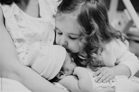 View Sister Meeting Her Newborn Brother For The First Time By Stocksy