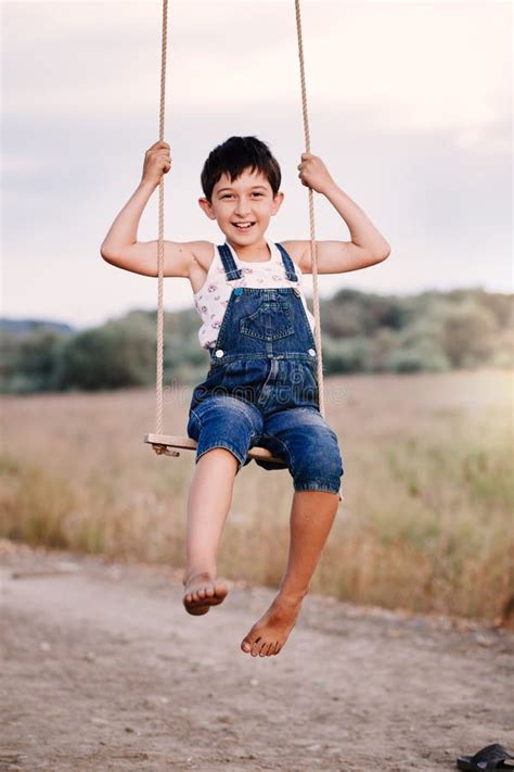 Happy Young Boy Playing On Swing In A Park Stock Image Image Of