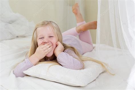 Tired Cute Child Girl Yawning In The Bed Stock Photo By ©chupacabra