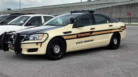 Two Police Cars Parked Next To Each Other In A Parking Lot