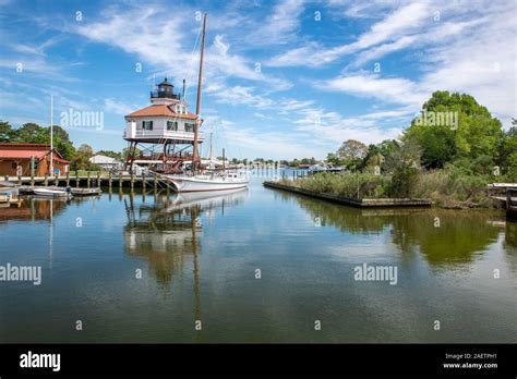 The Drum Point Lighthouse And A Boat Along The Dock Of The Calvert