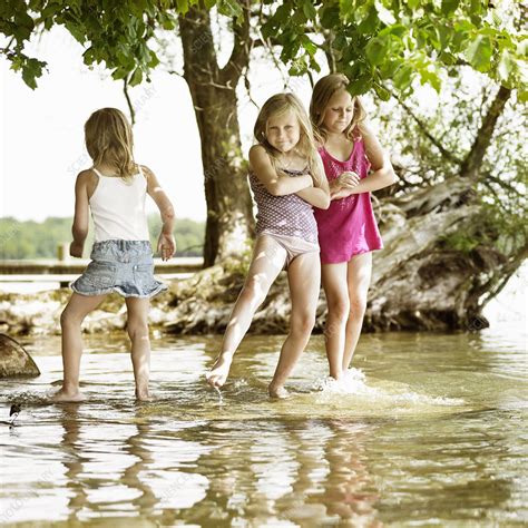 Smiling Girls Playing In Lake Stock Image F004 4958 Science Photo Library