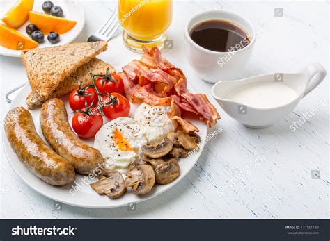 Healthy Full English Breakfast Plate With Poached Eggs Sausages Mushrooms Toasts And Bacon
