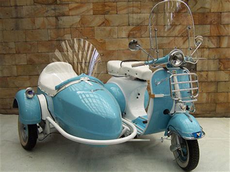 Well you're in luck, because here they come. Arsscoot.com - Piaggio Vespa Scooter and Sidecar