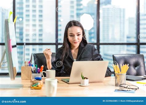 Happy Success Young Asian Business Women Sitting At Her Desks In The