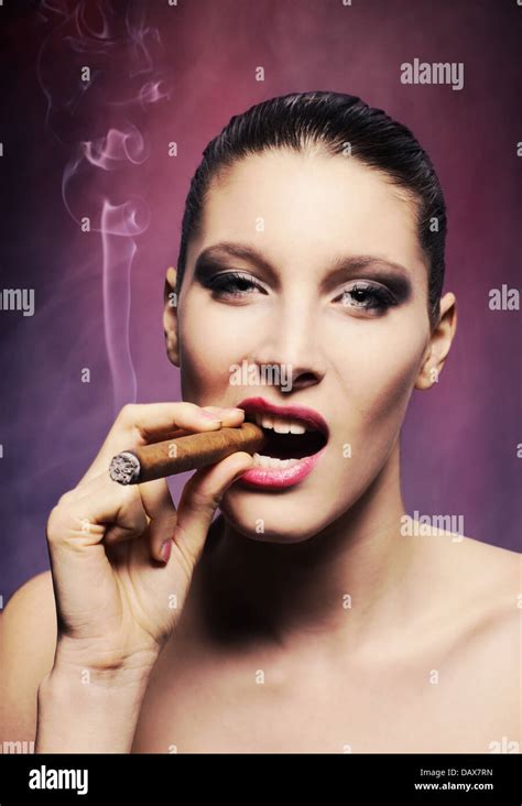 Attractive Young Woman Smoking A Cigar Stock Photo Alamy