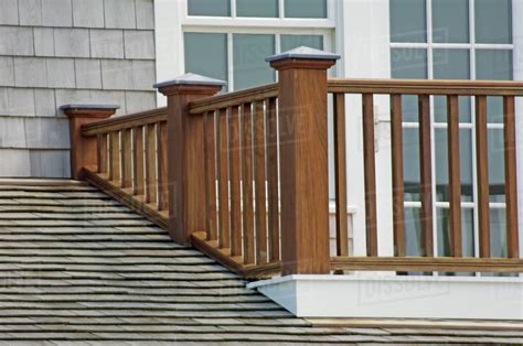 Balcony railing accessories is agreed important for your home. Wooden balcony railing and shingled roof - Stock Photo ...