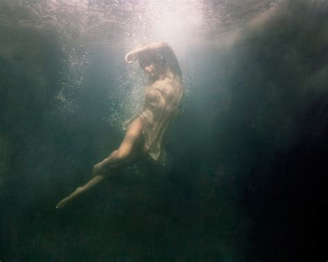 Eerily Floating In A Dark Underwater Abyss