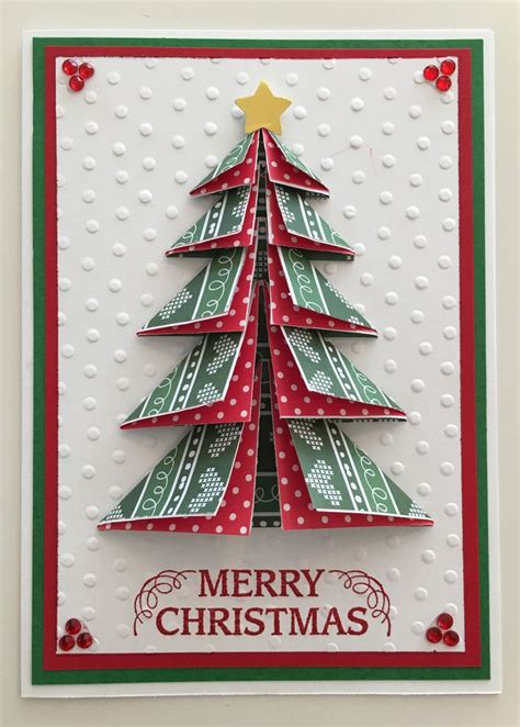 A Christmas Card With A Tree Made Out Of Folded Paper And The Words