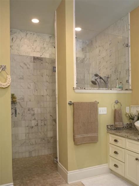 A Bathroom With Yellow Walls And Marble Counter Tops Along With A Walk