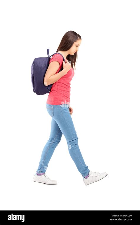 Full Length Portrait Of A Sad Female Student Walking With A Backpack