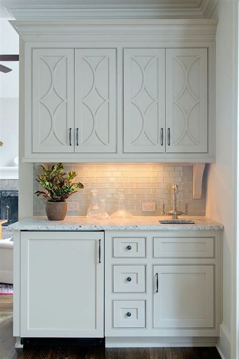 Фото из проекта farmhouse kitchen taupe painted cabinets,quartz tops, and dark island. Integrate Taupe Paint into Your Kitchen