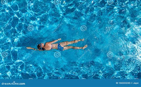 Aerial Top View Of Woman In Swimming Pool Water From Above Tropical