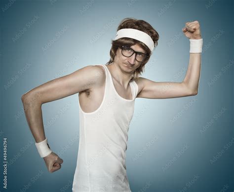 Funny Retro Nerd Flexing His Muscle Over Blue Background Stock Photo