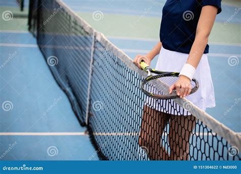 Woman Tennis Player Smiling While Holding The Racket During Tennis