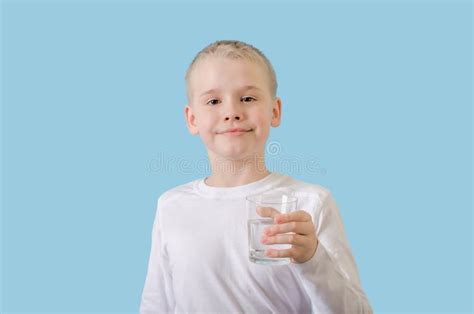 Child Holds Glass Of Water In His Hands Blond Little Boy With Water