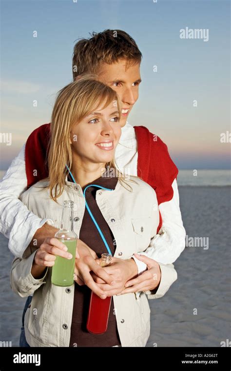 1221209 Outdoor Beach Sand Summer Evening Couple Man Dark Haired Young Woman Blonde Long Hair 25