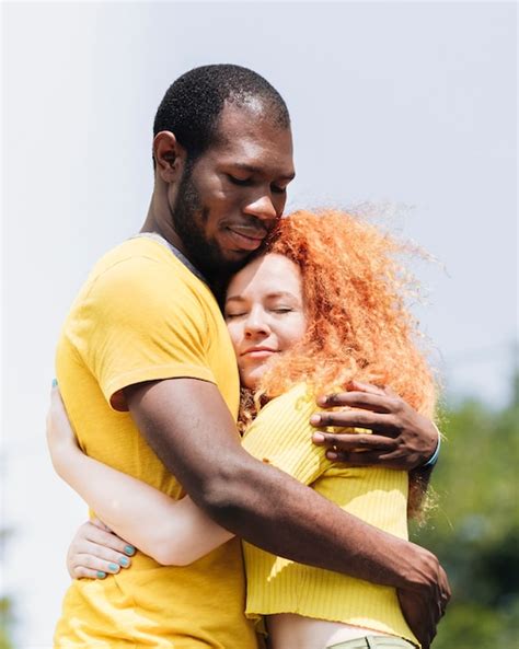 Premium Photo Side View Of Interracial Couple Hugging
