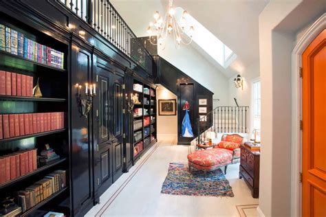 Traditional library with a fireplace, hardwood flooring and a rug. These 38 Home Libraries Will Have You Feeling Just Like Belle