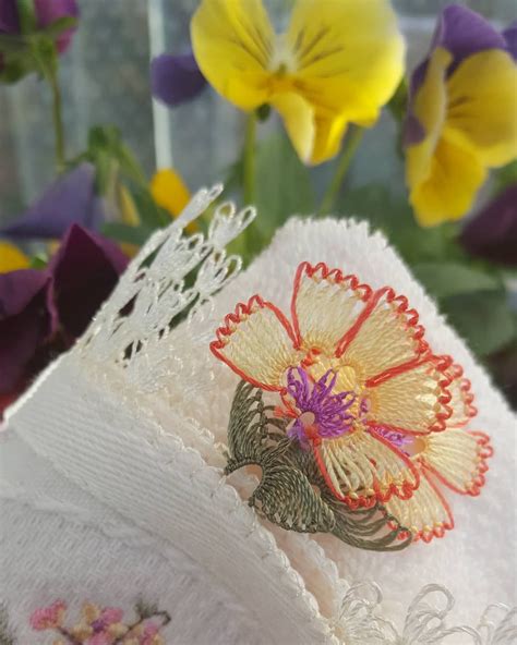 A Close Up Of A Towel With Flowers In The Background