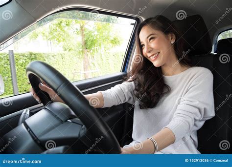 Asian Women Driving A Car And Smile Happily For Travel Stock Photo