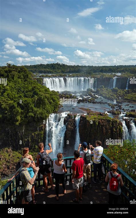 Tourists On Viewing Platform On Brazil Side Of Iguazu Falls Looking At