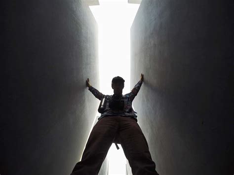 Person Low Angle Photo Of Man Standing Between Walls Lighting Image Free Photo