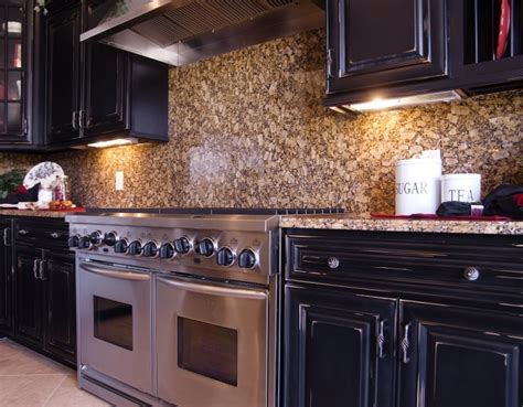 Rather than just an expanse of granite for a significant addition of storage space, you can install glass cabinets under your regular cabinetry. Dark Cabinet Kitchen Designs • Art of the Home