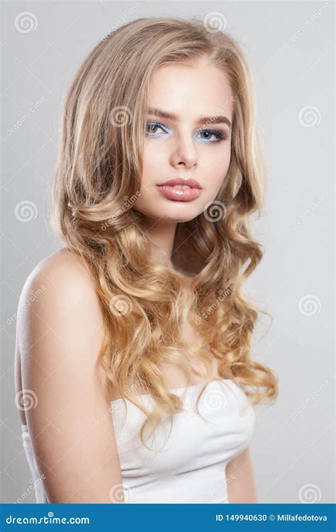 Portrait Of Beautiful Blonde Woman With Long Curly Hair Stock Photo