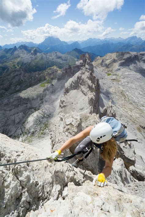 Attractive Female Climber On A Steep Via Ferrata In The Italian