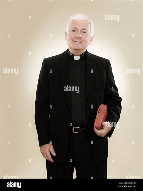 Portrait Of A Priest Holding A Bible Stock Photo Alamy
