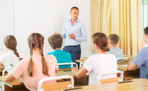 Teacher Explaining The Math Near Chalkboard Stock Photo Image Of