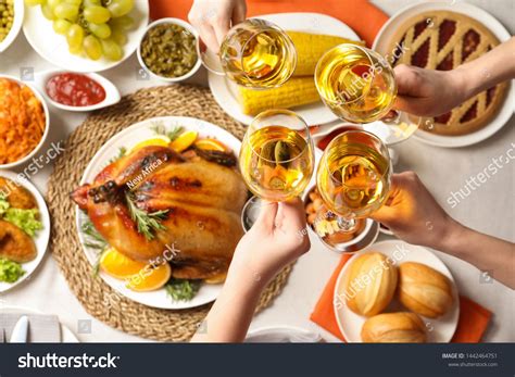 More than 61% of the population or 177 million people in the united states need some sort of vision correction. People holding glasses of wine over table with festive ...