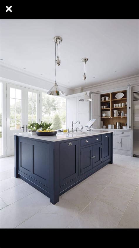 You can layer in contrast with black countertops and a light backsplash. Light gray cabinetry and navy island. | Blue kitchen ...